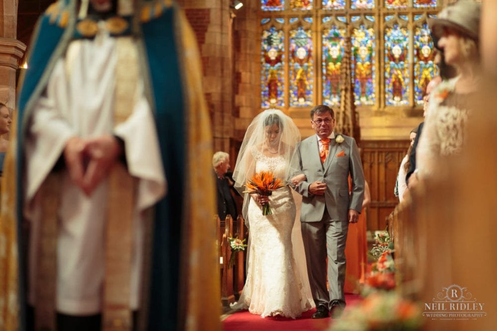 Bride walks down the aisle with her F her father is crying at St Thomas Church in St Annes-on-Sea