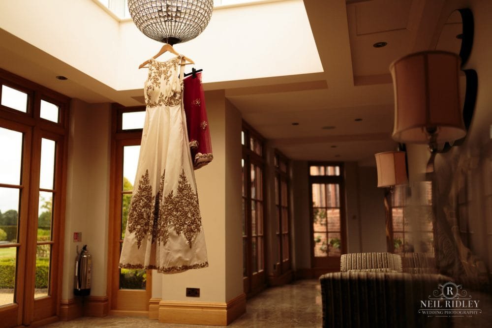 Merrydale Manor Wedding Photographer - Wedding Dress hangs from a light fitting