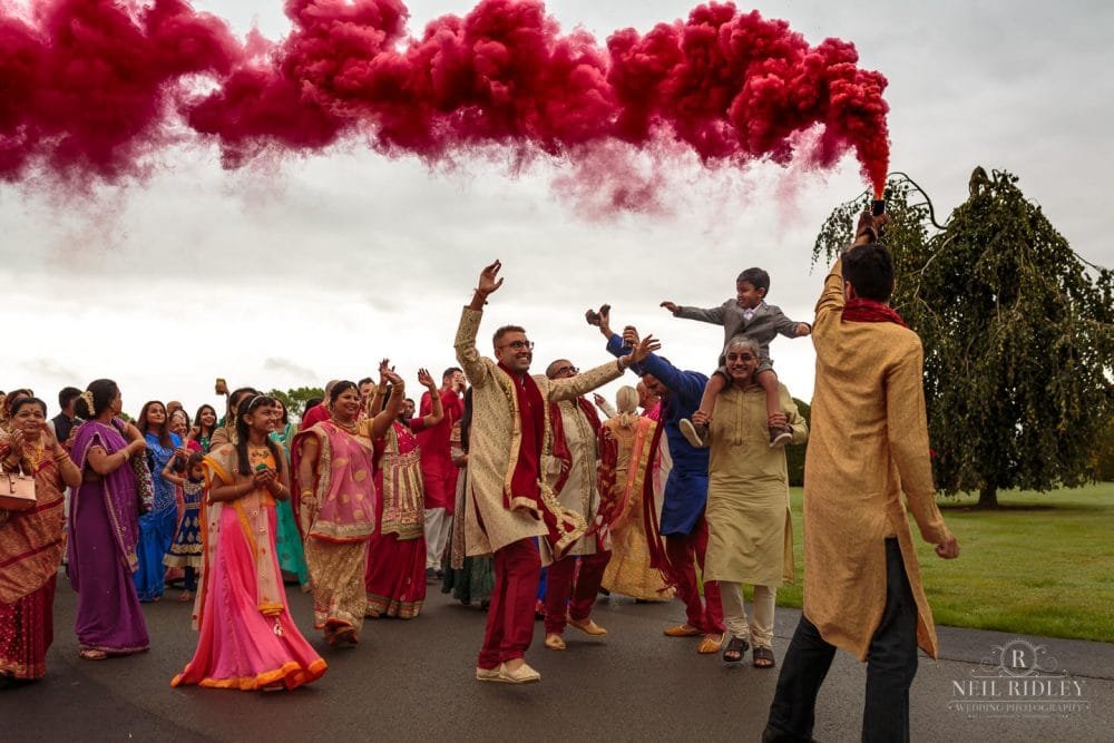Merrydale Manor Wedding Photographer - Red smoke bomb over the Baraat