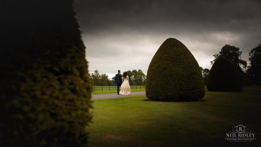 Merrydale Manor Wedding Photographer - Bride and Groom walking in the grounds