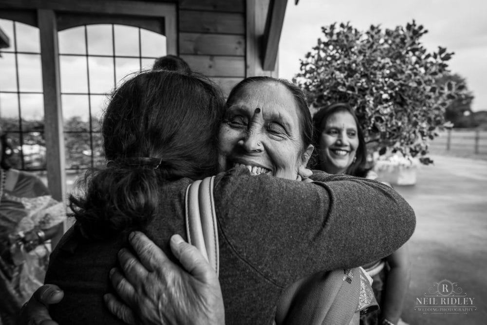 Merrydale Manor Wedding Photographer - Hindu wedding guests embrace