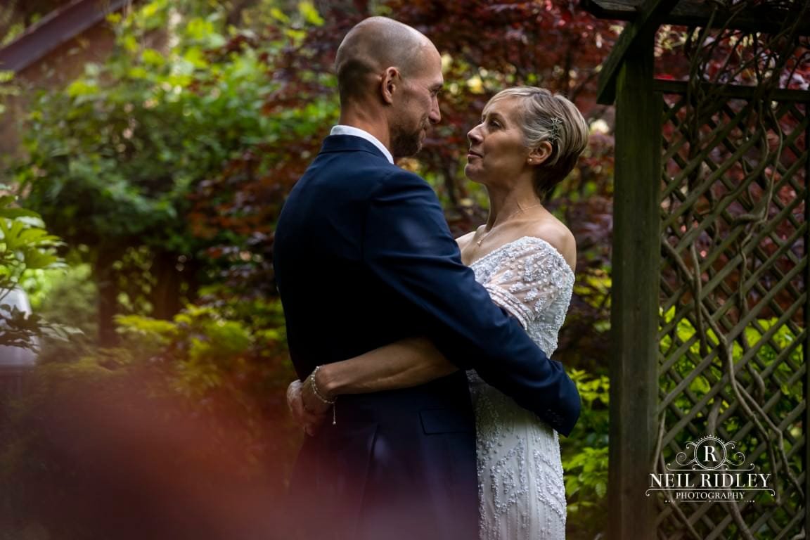 Didsbury House Wedding Photographer couple cuddle in the gardens
