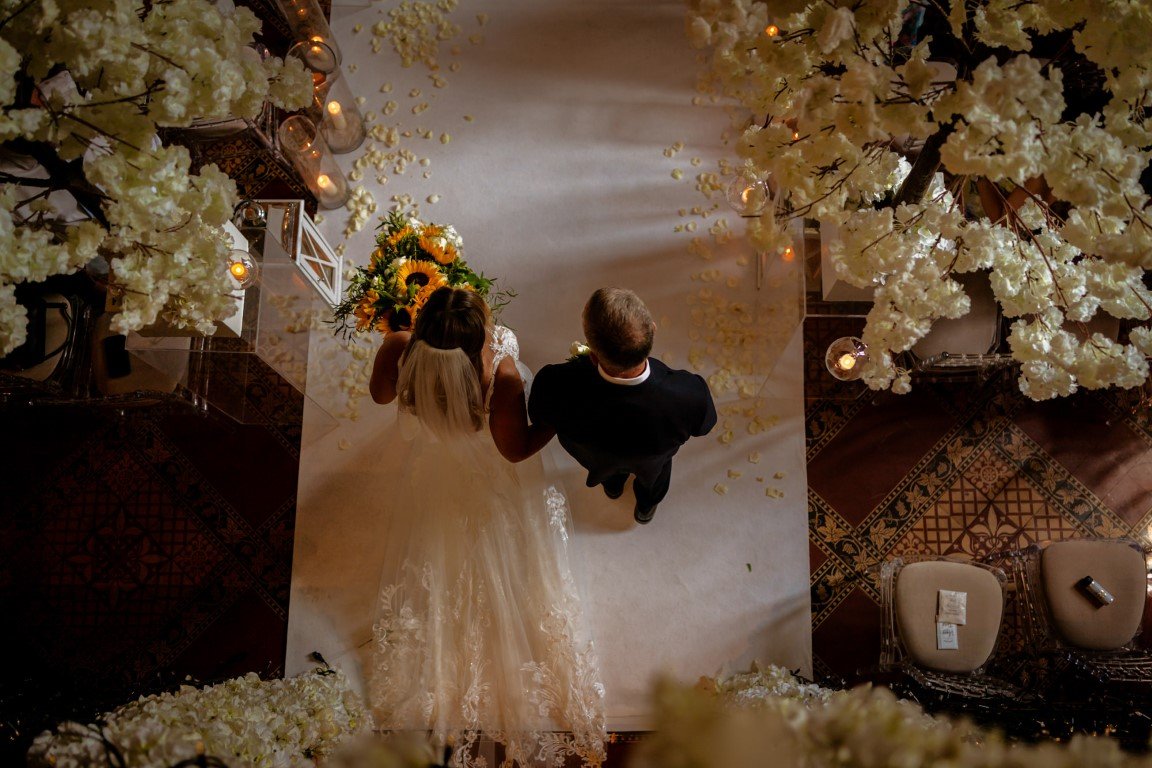 NR903901 Peckforton Castle Wedding Bride enters the Great Hall viewd from above