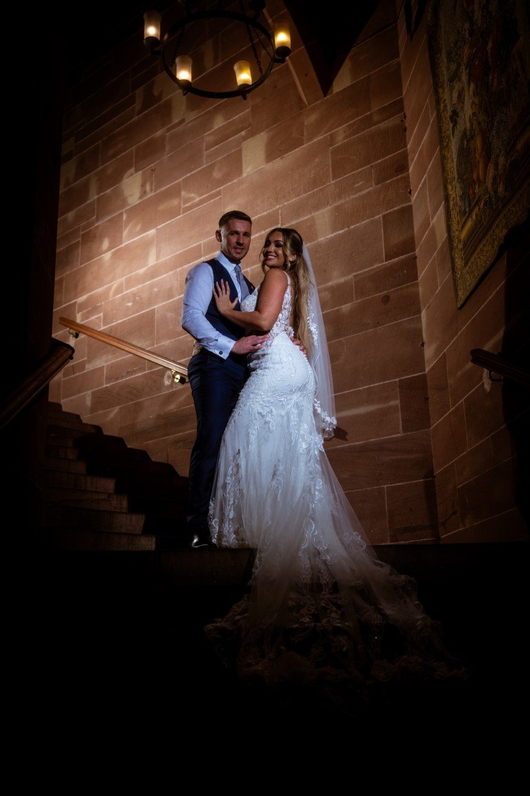 NR906473 Peckforton Castle Wedding Bride and Groom on the staircase