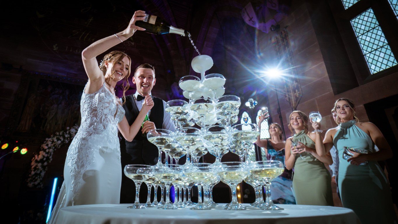 NRA04327 Peckforton Castle Wedding Bride and Groom Champagne Tower