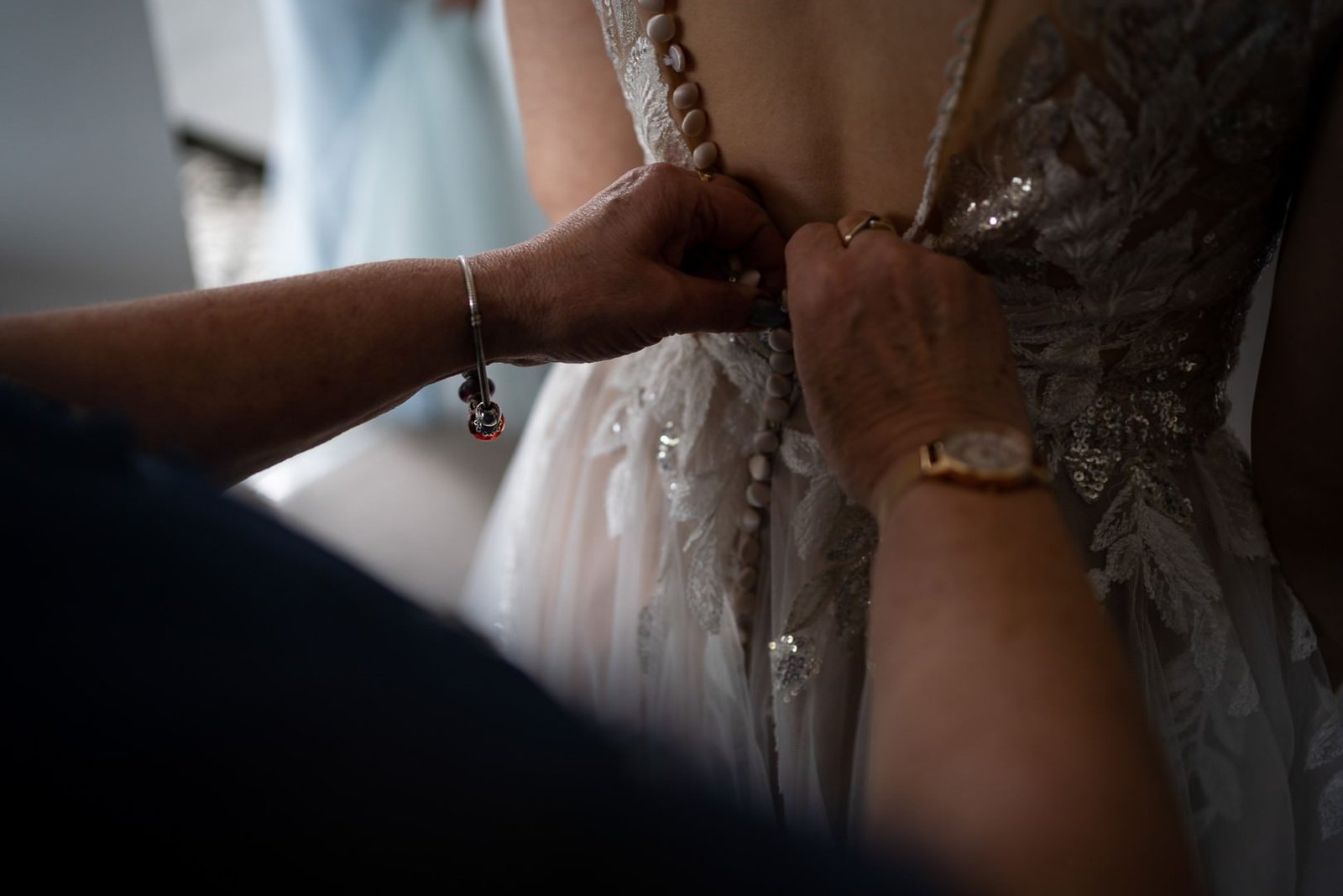 dress The Out Barn Wedding Photographer Fastening the dress