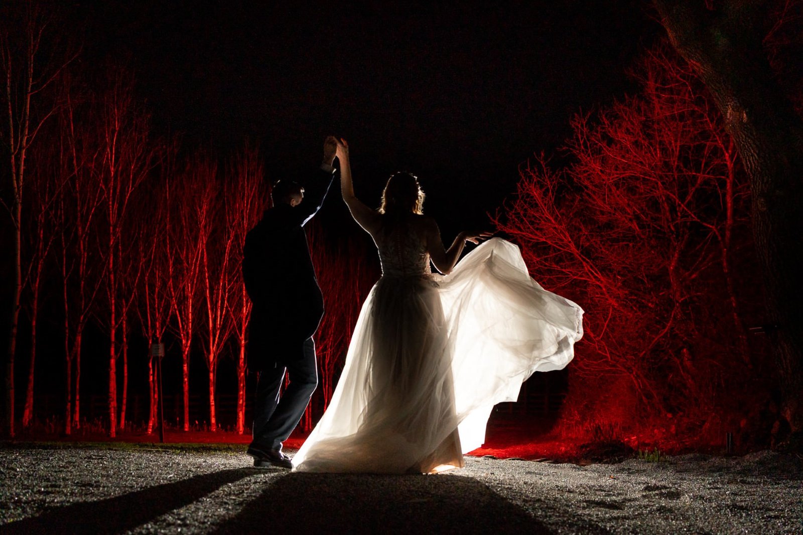 flash The Out Barn Wedding Photographer Bride dancing at night outside an lit with flash